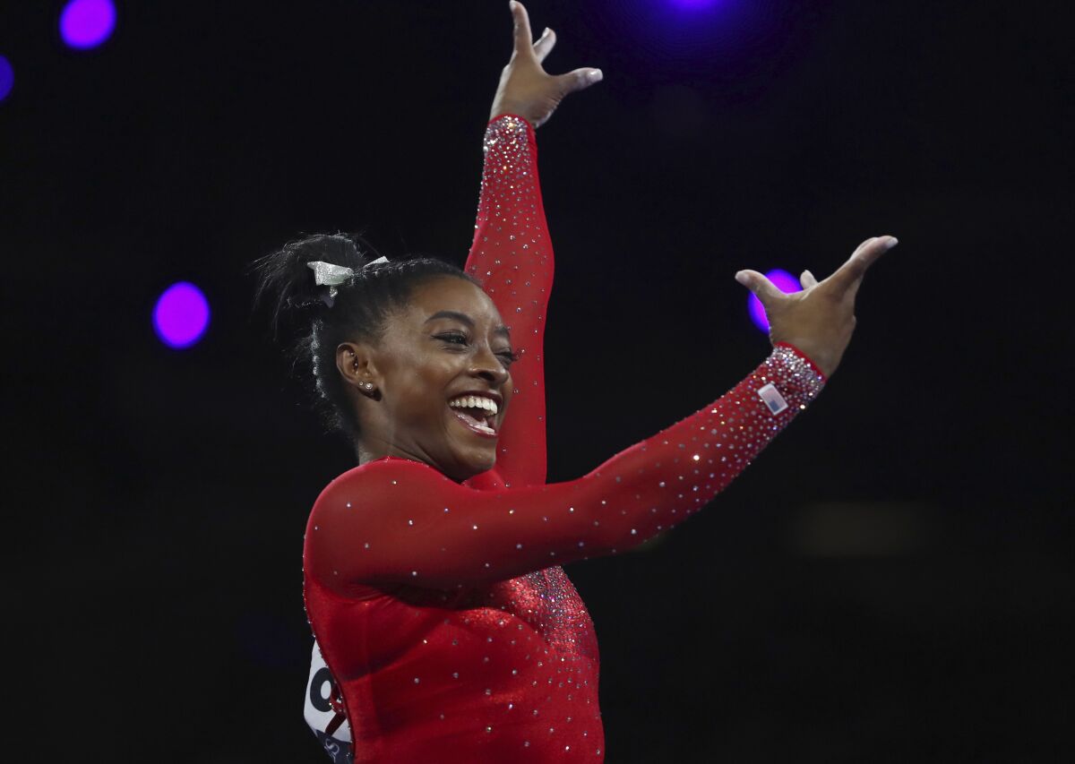 Simone Biles reacts after completing her vault during her gold-medal winning effort Saturday at the gymnastics world championships.