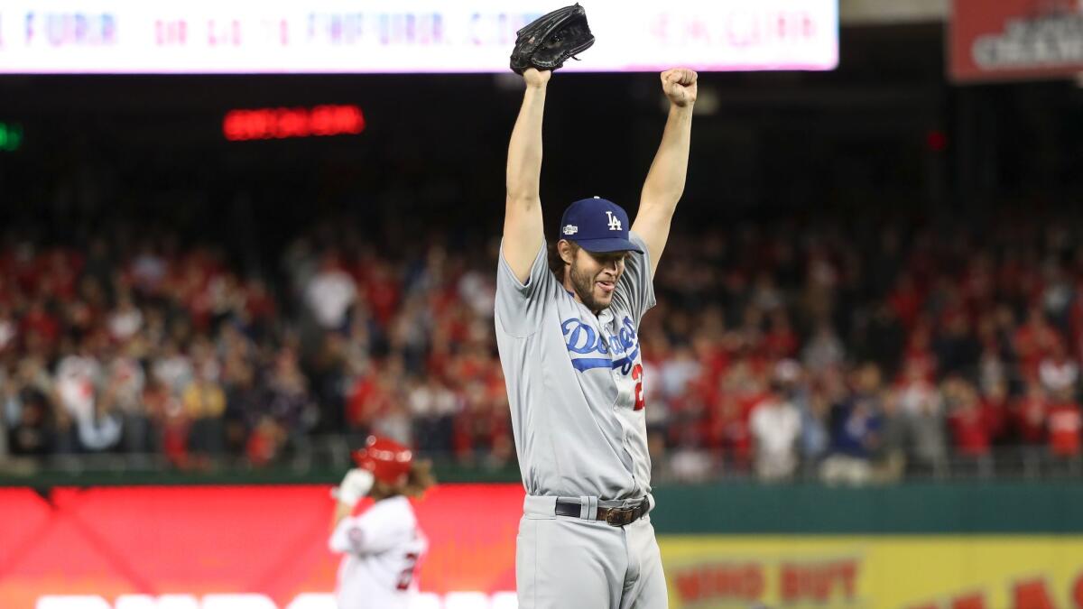 Clayton Kershaw raises his arms in victory after pitching the final two outs for the Dodgers against the Nationals on Oct. 13, 2016.