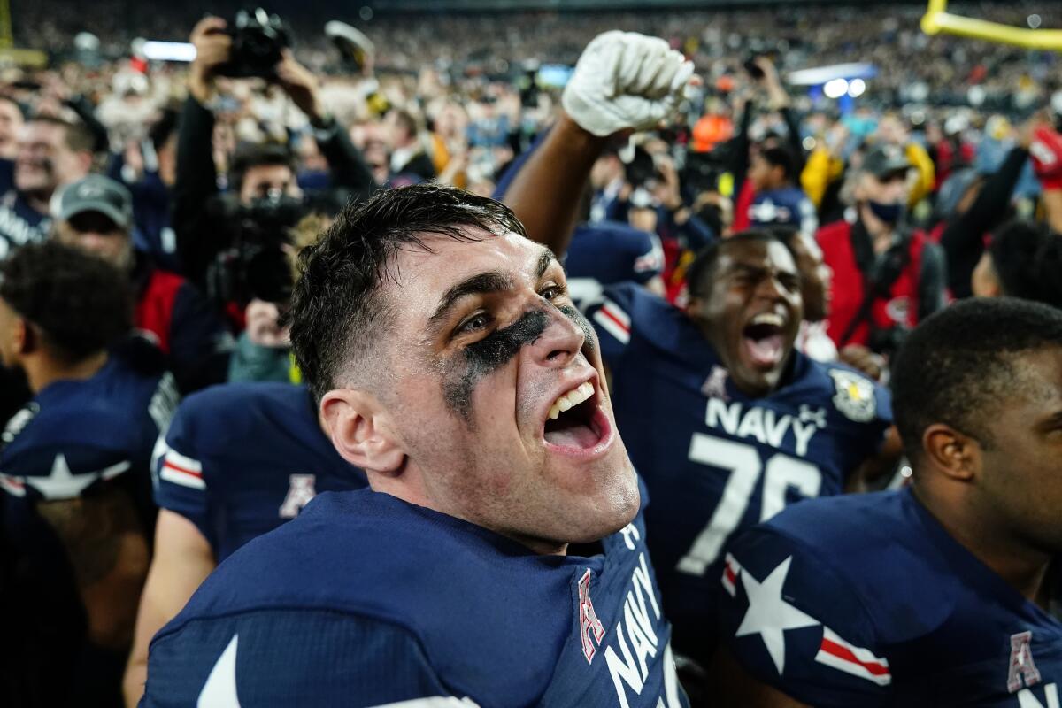 Navy players rejoice in their 17-13 win over Army on Dec. 11, 2021, in East Rutherford, N.J.