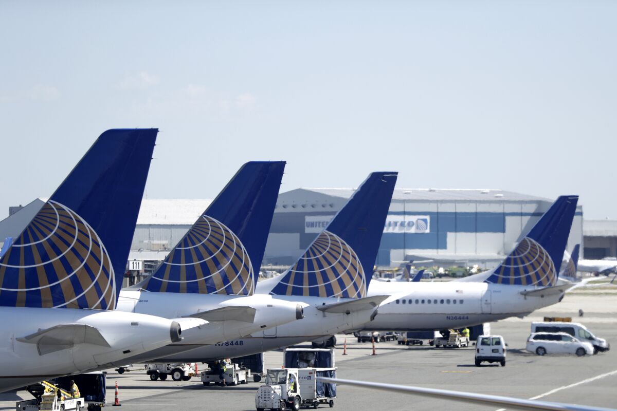 FILE - In this July 18, 2018, file photo, United Airlines commercial jets sit at a gate at Terminal C of Newark Liberty International Airport in Newark, N.J. Federal safety regulators have approved steps that will let United Airlines resume using dozens of Boeing 777 jets that have been grounded since the engine on one plane blew apart over Denver last year. The Federal Aviation Administration on Tuesday, May 17, 2022, confirmed that it has approved steps necessary for flights to resume using the planes, which have engines made by Pratt & Whitney. (AP Photo/Julio Cortez, File)