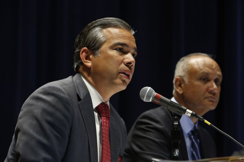 LOS ANGELES, CA - Dec. 1, 2015: State legislators including California State Assembly member Rob Bonta, left, and Sen. Ed Hernandez, right, discuss a tax to fund Medi-Cal during an informational hearing titled "Managed Care Organization Tax Overview," held in the auditorium of the Ronald Reagan State Building in Los Angeles. Way more people signed up for Medi-Cal than anyone expected, and now the state is paying $18 billion for the program - more than 10% of the state's total budget. Those costs are only going to climb in the coming years. (Photo by Katie Falkenberg / Los Angeles Times)