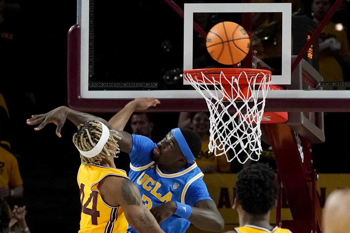 UCLA's Adem Bona thwarts a dunk attempt by Arizona State guard Adam Miller.