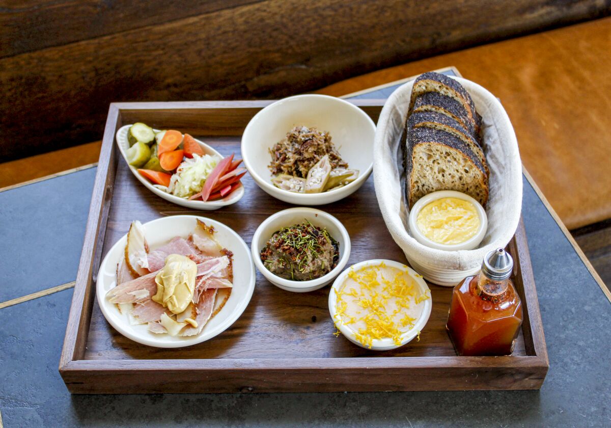 A tray with several plates of food.
