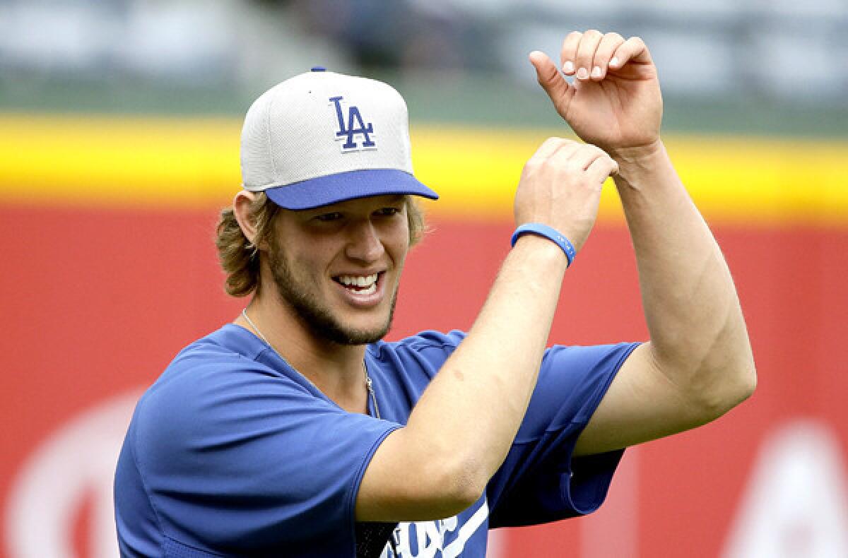 Dodgers ace Clayton Kershaw warms up before practice in Atlanta on Wednesday.