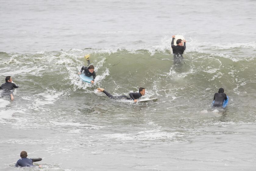Surfers and boogie boarders angle for position at the Wedge in Newport Beach on Thursday, April 9.