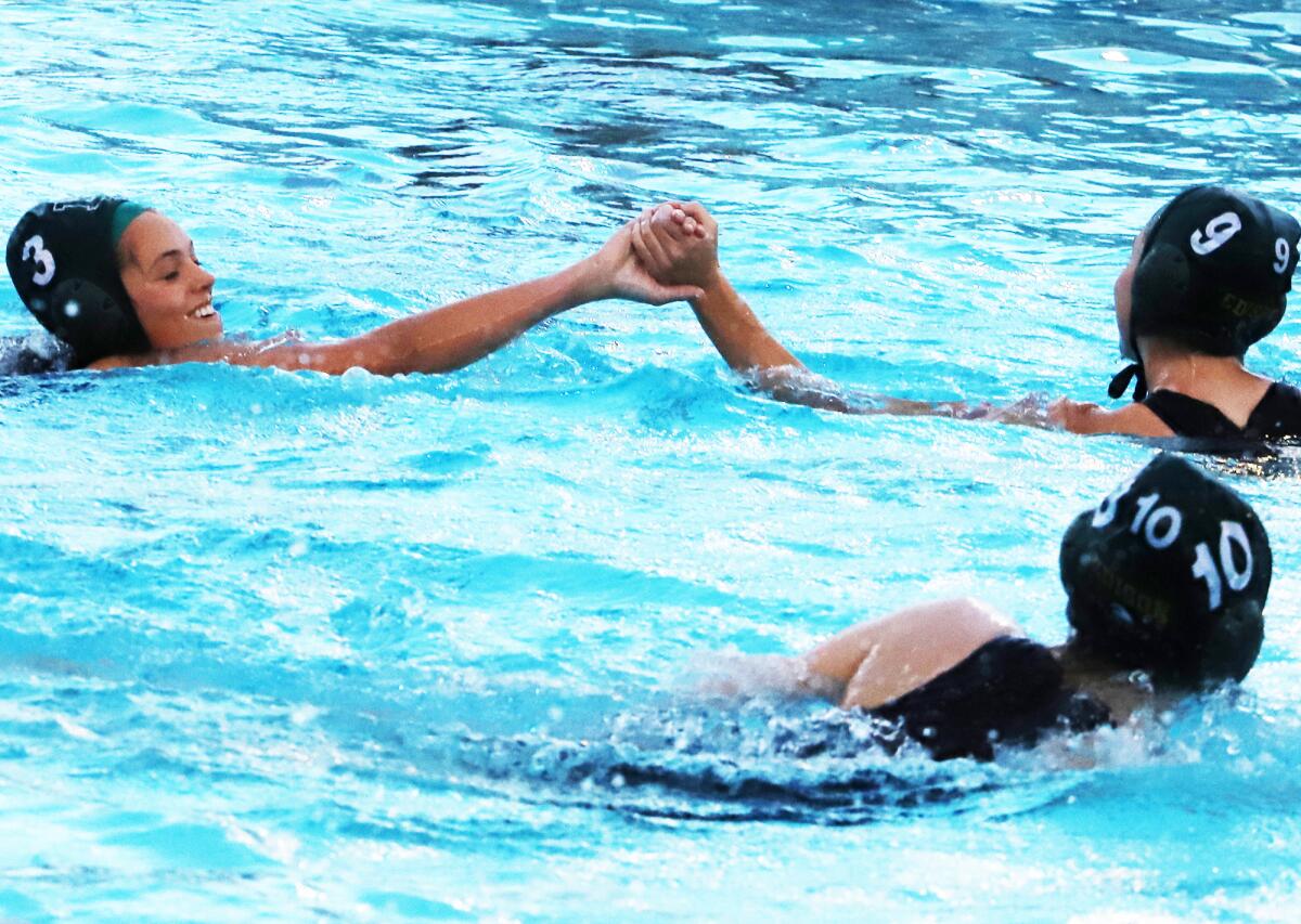 Edison's Falon Johnson (3) and Kenna Boehm (9) bump fists after a goal against Woodbridge on Wednesday night.