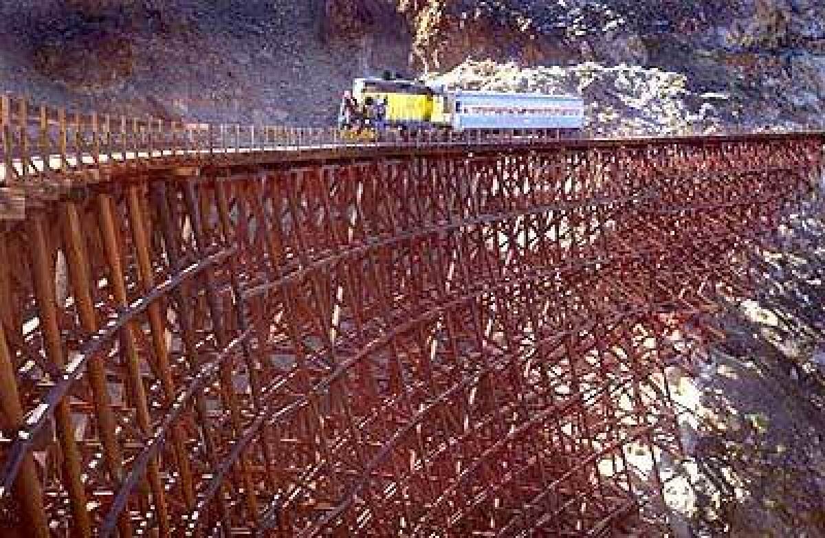 An engine pulls a sightseeing car over the 630-foot-long Goat Canyon Trestle on the Carrizo Gorge line in preparation for the return of freights. Bikers and hikers, long accustomed to having their way with the Anza-Borrego stretch, hope for continued access.