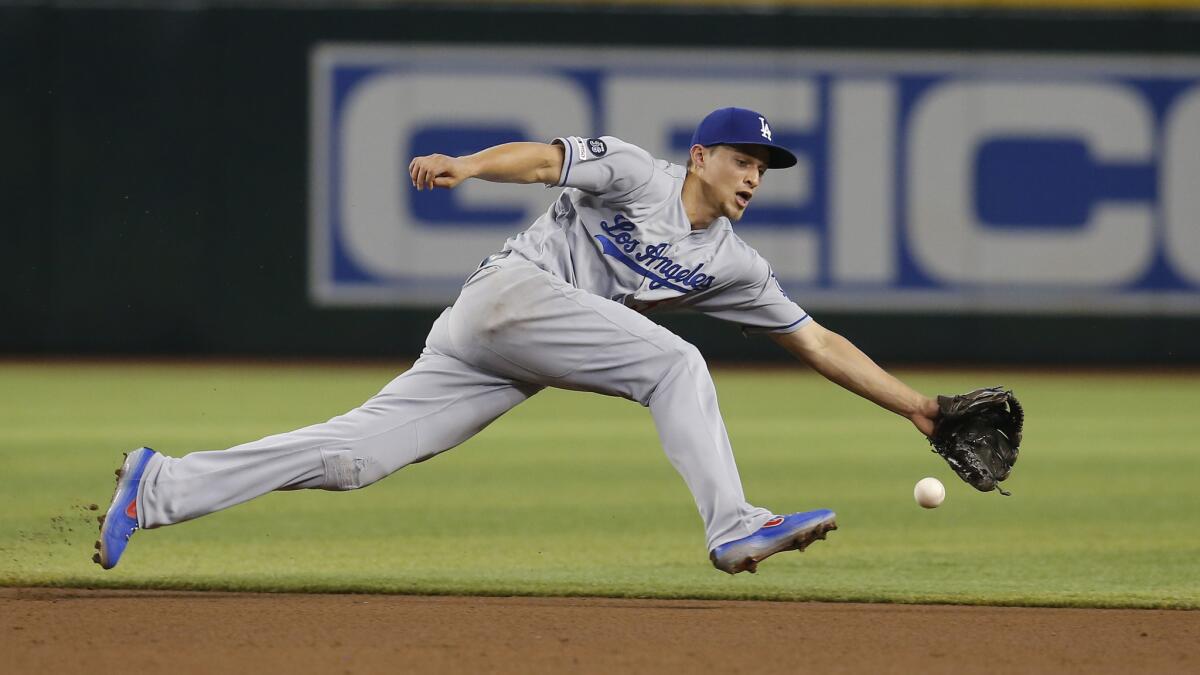 Dodgers shortstop Corey Seager reaches for the ball on a single hit by Arizona Diamondbacks center fielder Jarrod Dyson in the fourth inning of the Dodgers’ loss on Wednesday.