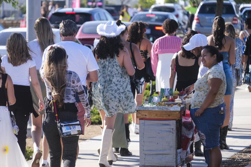 Street vendors sell hot dogs outside of SoFi Stadium during Taylor Swift's Eras Tour on Thursday, August 3, 2023. (Ringo Chiu / For De Los)