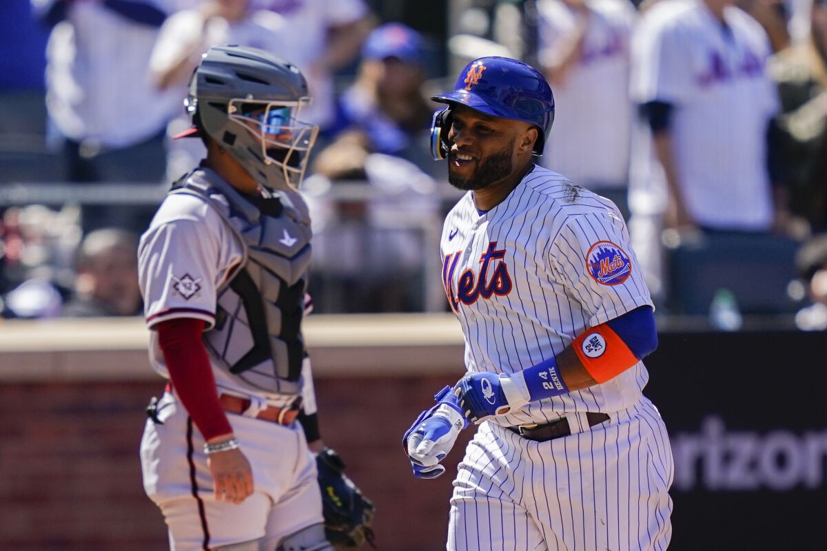 New York Mets' Robinson Cano celebrates after hitting a solo home run off Arizona Diamondbacks starting pitcher Zach Davies in the fourth inning of a baseball game, Friday, April 15, 2022, in New York. (AP Photo/John Minchillo)