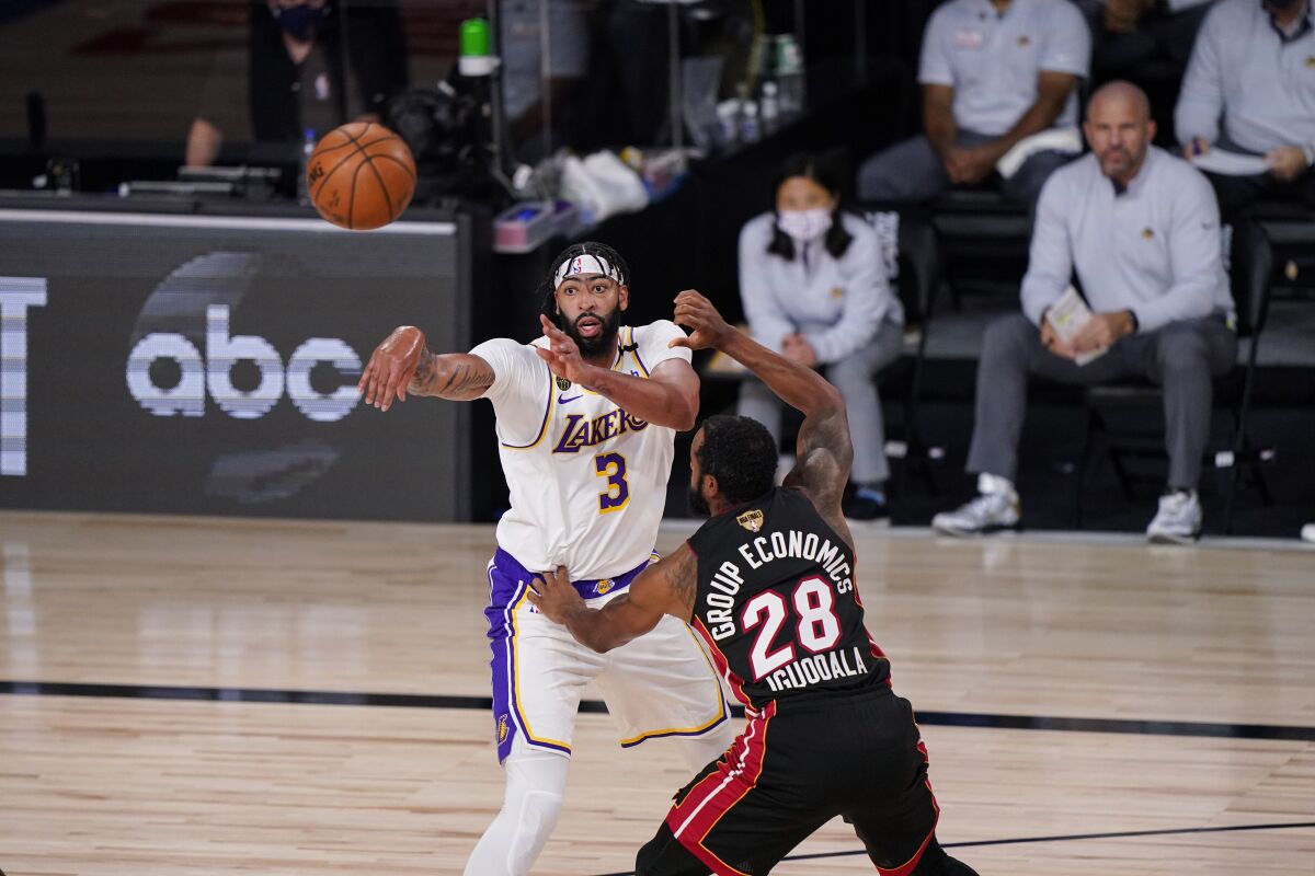 Lakers forward Anthony Davis makes a pass over Heat forward Andre Iguodala during Game 3.