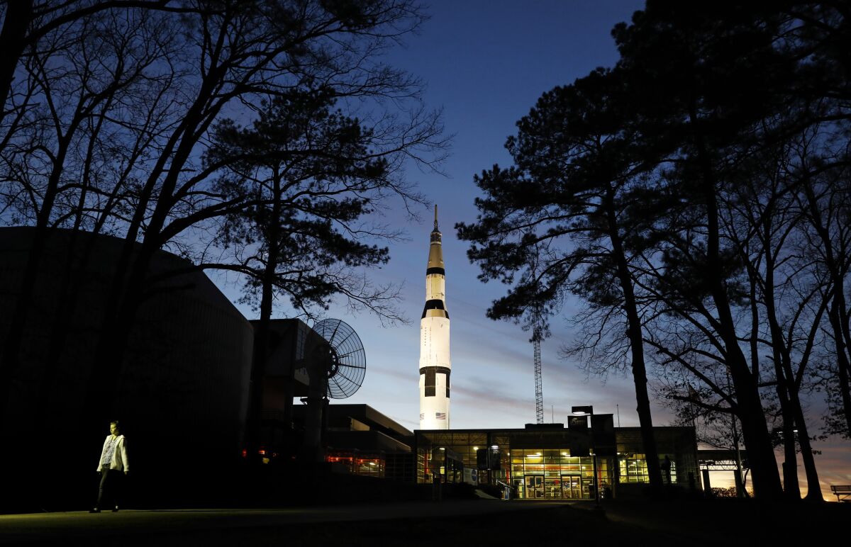 FILE - An employee leaves the state operated U.S. Space & Rocket Center, which serves as the visitor center for the nearby federally funded NASA Marshall Space Flight Center, in Huntsville, Ala. in this Tuesday, Jan. 8, 2019 file photo. Space Camp, an educational program attended by nearly 1 million people, said Tuesday July 28, 2020 it's in danger of closing without a cash infusion because of the coronavirus pandemic.(AP Photo/David Goldman, File)