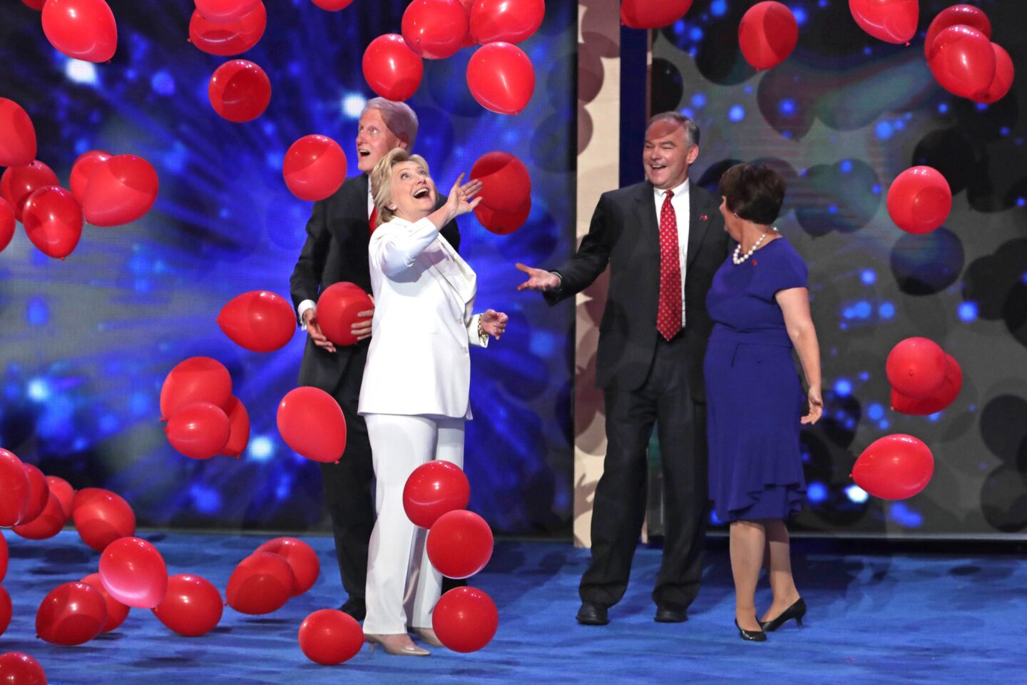 Democratic presidential candidate Hillary Clinton stands with her husband former President Bill Clinton on stage with Vice President nominee Tim Kaine and his wife Anne Holton at the end of the fourth day of the Democratic National Convention.