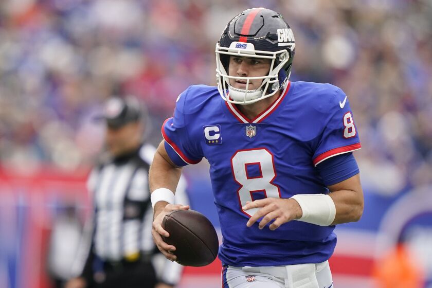 New York Giants quarterback Daniel Jones (8) runs for a touchdown against the Chicago Bears during the first quarter of an NFL football game, Sunday, Oct. 2, 2022, in East Rutherford, N.J. (AP Photo/John Minchillo)