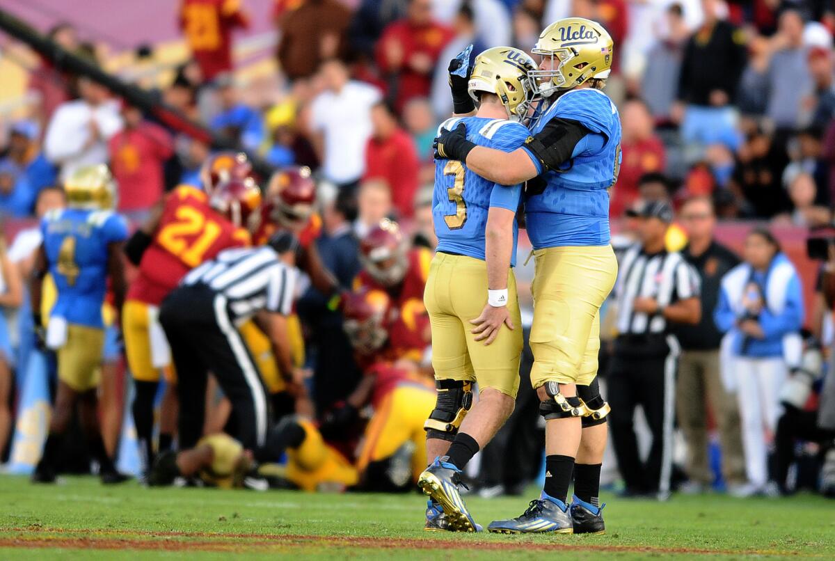 UCLA quarterback Josh Rosen is consoled by offfensive lineman Conor McDermott after having a pass intercepted by USC in the fourth quarter.
