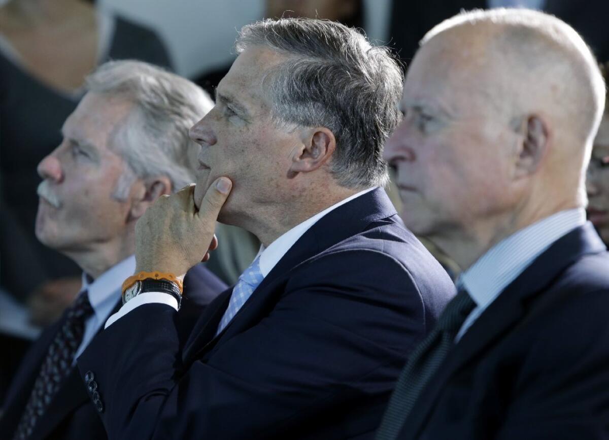 Oregon Gov. John Kitzhaber, left, Washington Gov. Jay Inslee and California Gov. Jerry Brown listen to a speaker on Oct. 28 in San Francisco before signing an agreement to collectively combat climate change. Kitzhaber was honored as one of Governing Magazine's public officials of the year.