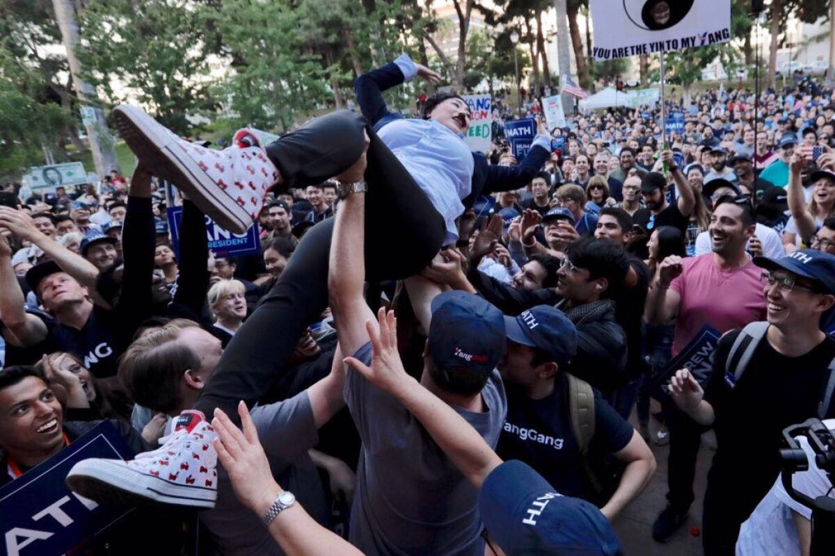 An Andrew Yang impersonator crowd surfs at his MacArthur Park rally last week.