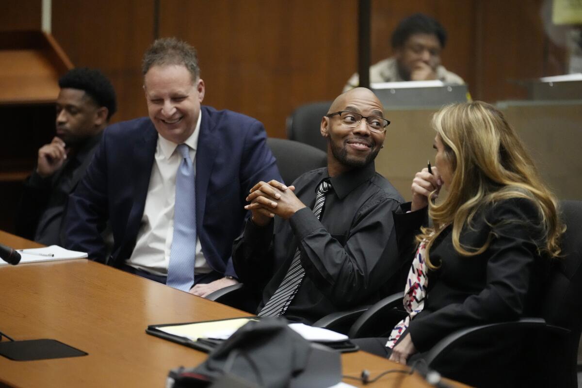 Juan Rayford and Dupree Glass sit with their attorneys Eric Dubin and Annee Della Donna during a hearing on their case.