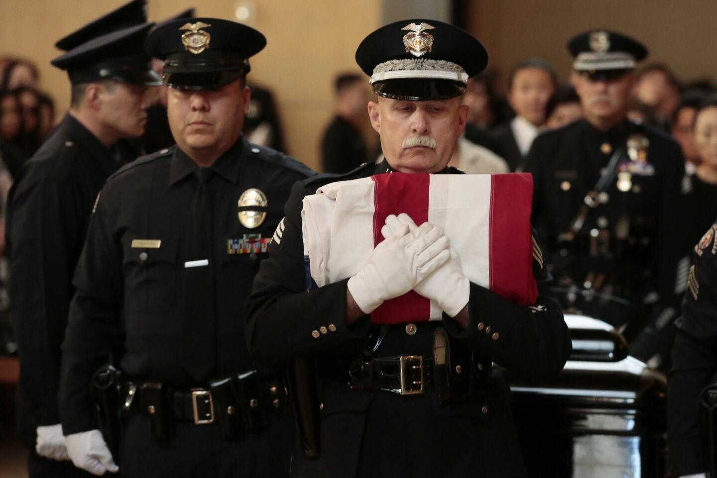 Sergeant holds flag at service