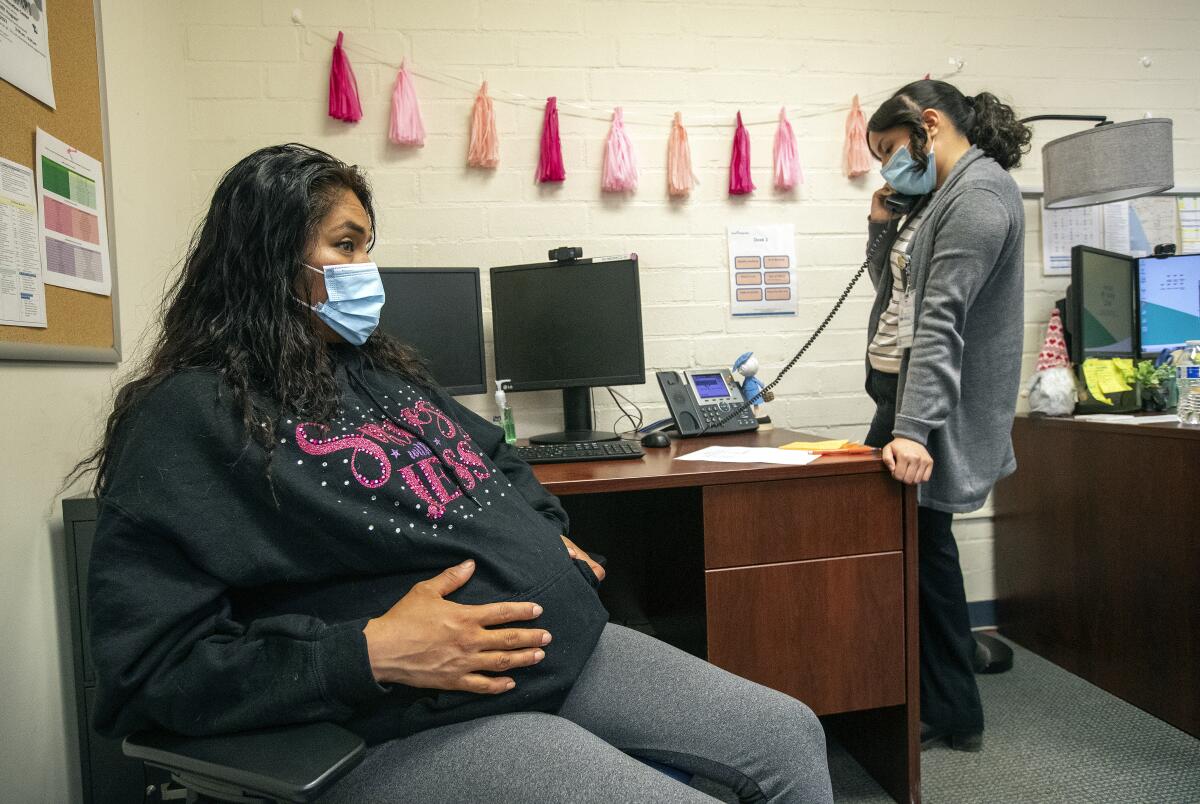 A health insurance specialist and a pregnant client at the Venice Family Clinic