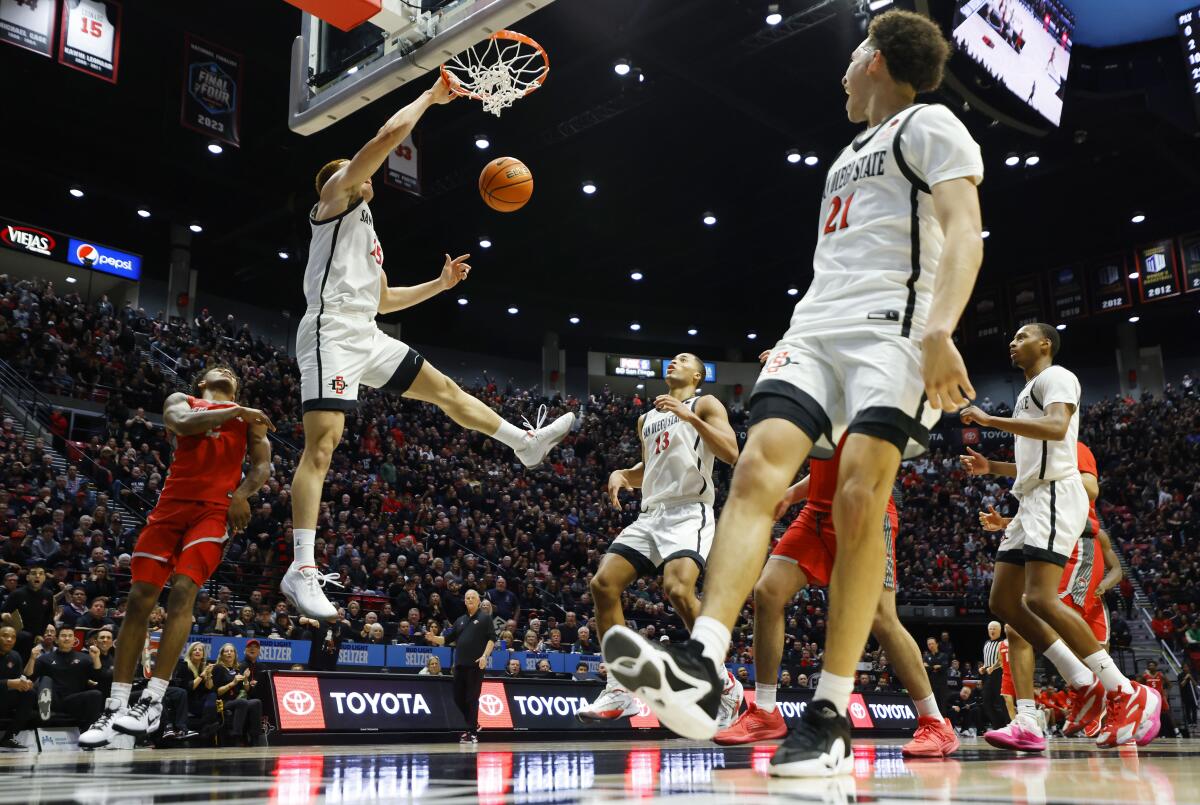 San Diego CA - February 16: SDSU's Elijah Saunders slams the ball on an alley-oop from Miles Byrd against New Mexico Friday.