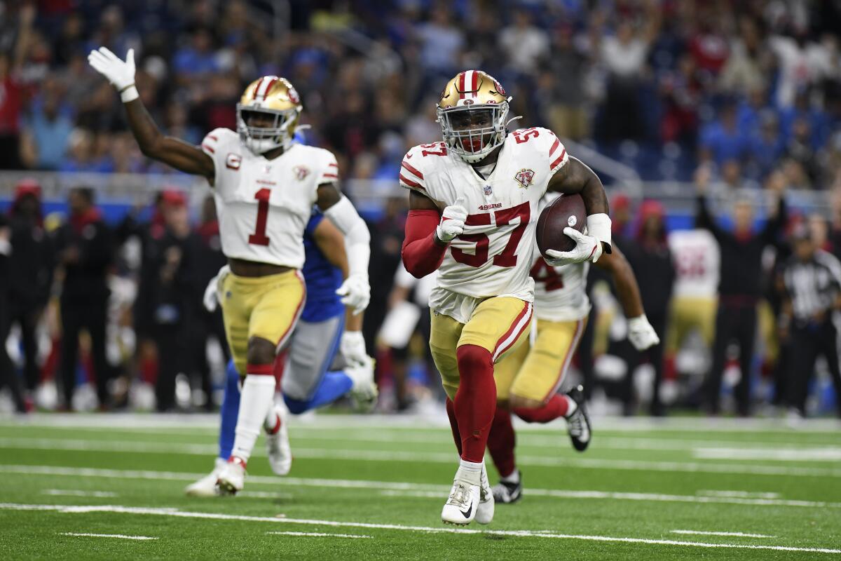 San Francisco 49ers linebacker Dre Greenlaw (57) returns an interception for a 39-yard touchdown against the Detroit Lions in the first half of an NFL football game in Detroit, Sunday, Sept. 12, 2021. (AP Photo/Lon Horwedel)