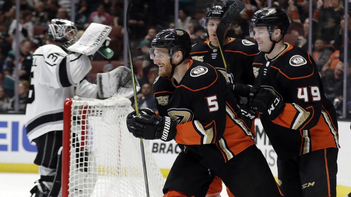 Ducks' Korbinian Holzer (5) celebrates his goal with teammates during the second period against the Kings on Friday at the Honda Center.