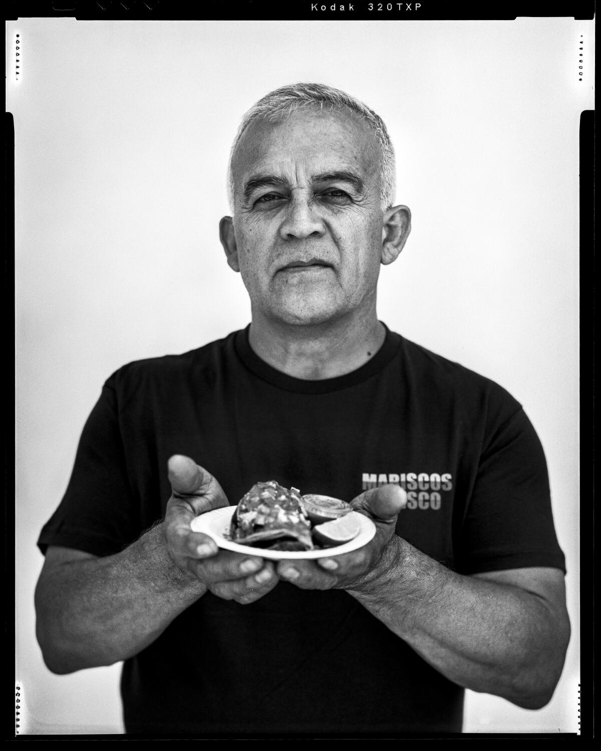 A man holds a plate with both hands.