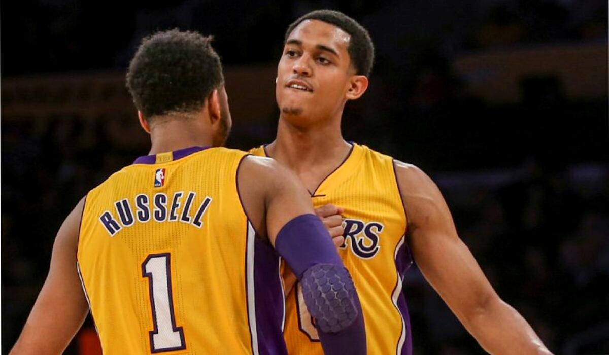 Los Angeles Lakers guard D’Angelo Russell, left, celebrates with teammate Jordan Clarkson during a timeout in the second half of an NBA basketball game against Orlando Magic on Tuesday, March 8, 2016, in Los Angeles. The Lakers won 107-98. (AP Photo/Ringo H.W. Chiu)