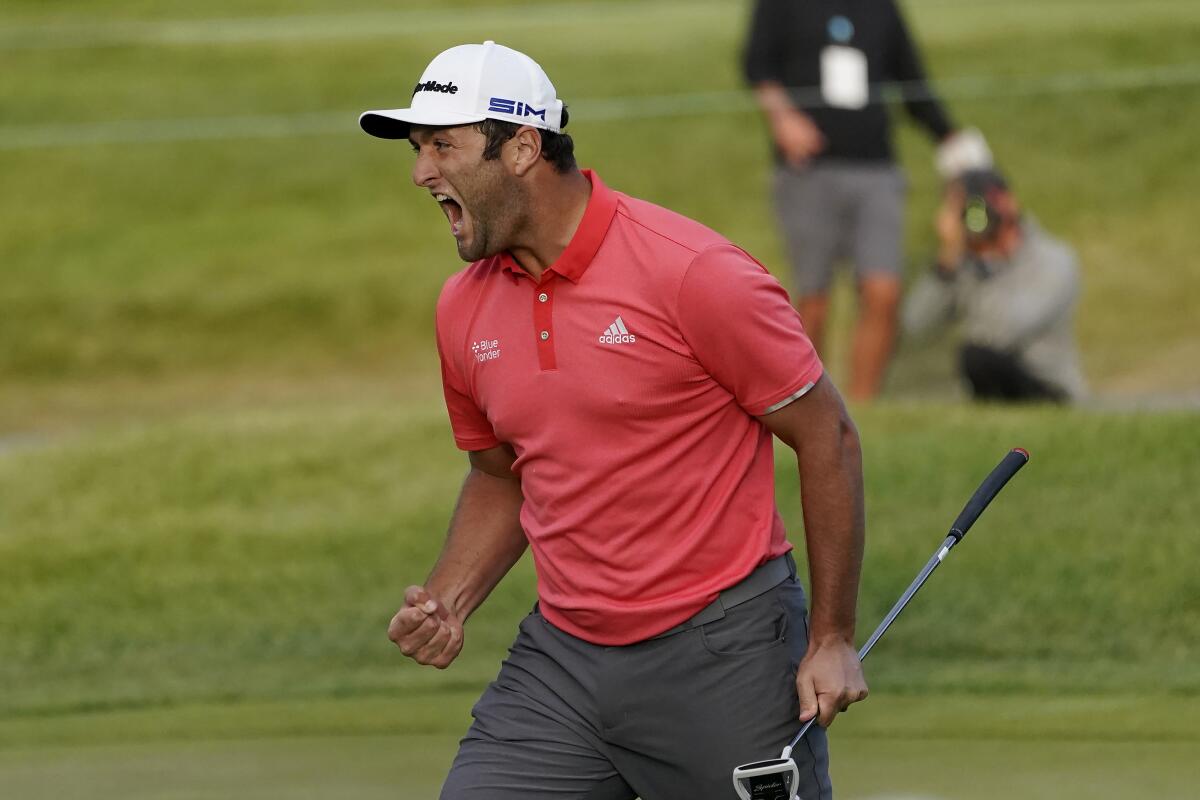Jon Rahm reacts after making his putt on the first playoff hole during the final round of the BMW Championship.