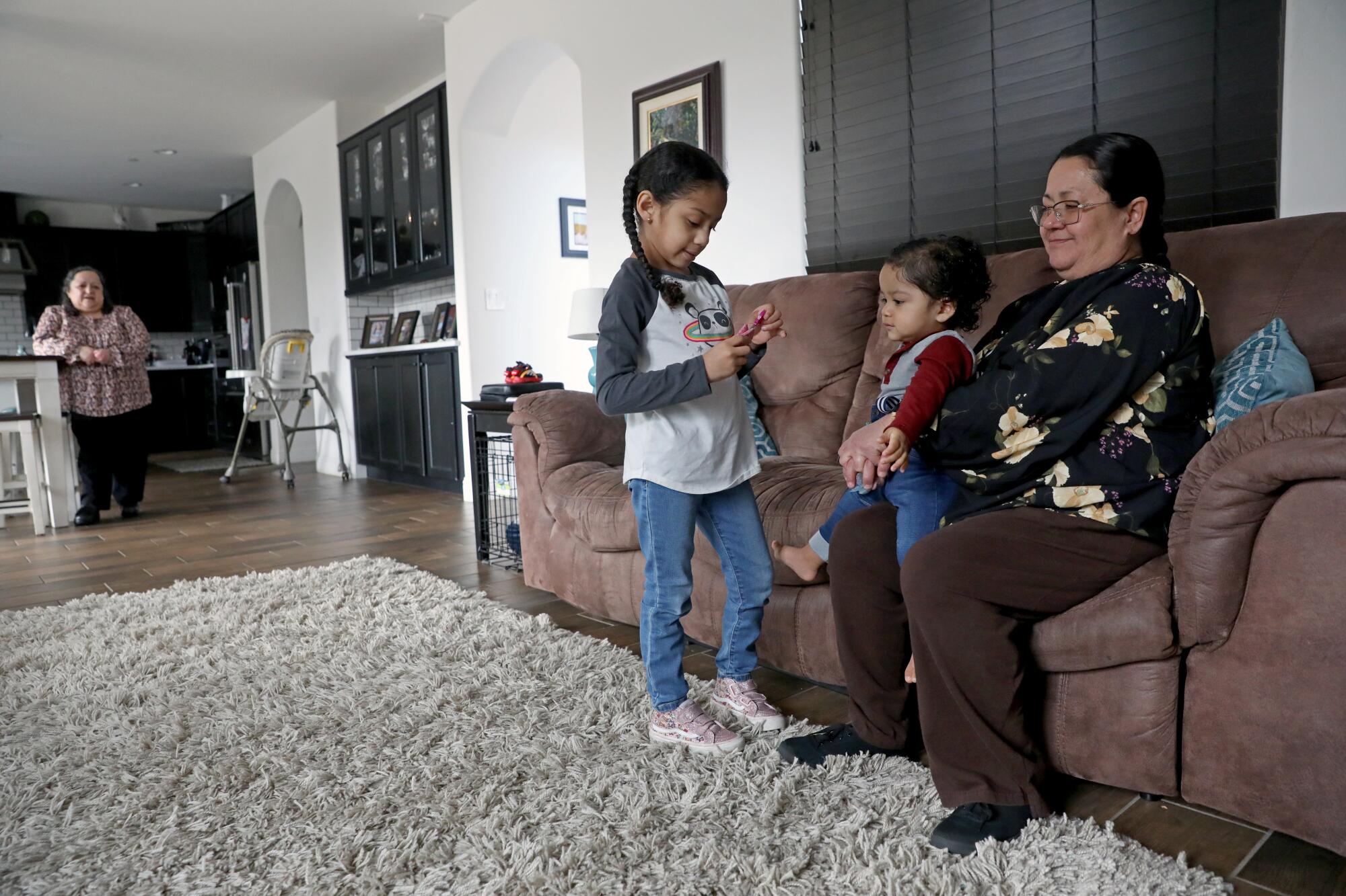 Lupe Mendoza, 55, helps take take care of her 10-month-old nephew Ryan Ramirez