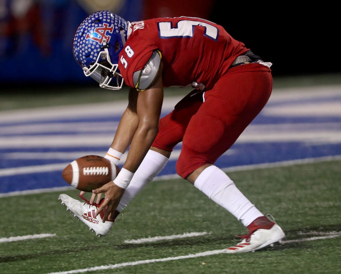 Los Alamitos High School football player #58 Michael-Allen Reddy picks up his own blocked punt and scores a TD in home game vs. Newport Harbor High School at Cerritos College in Norwalk on Friday, Oct, 5m 2018. NHHS lost 7-42.