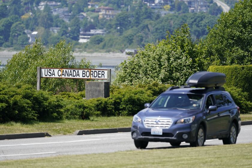 FILE - In this June 8, 2021, file photo, a car heads into the U.S. from Canada at the Peace Arch border crossing in Blaine, Wash. Canada is lifting its prohibition Monday, Aug. 9, on Americans crossing the border to shop, vacation or visit, but the United States is keeping similar restrictions in place for Canadians. The reopening Monday is part of a bumpy return to normalcy from COVID-19 travel bans. (AP Photo/Elaine Thompson, File)