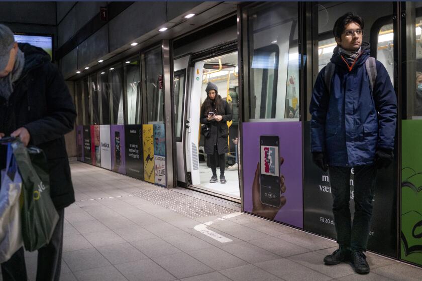 FILE - Passengers stand at the Noerreport Metrostation in Copenhagen Denmark, Tuesday, Feb. 1, 2022. Denmark has become one of the first European Union countries to scrap most pandemic restrictions as the country no longer considers the COVID-19 outbreak “a socially critical disease.” Bit by bit, many countries that have been especially hard-hit by the coronavirus are easing their tough, and often unpopular, restrictive measures to fight COVID-19 even as the omicron variant — deemed less severe — has caused cases to skyrocket. (Liselotte Sabroe/Ritzau Scanpix via AP)