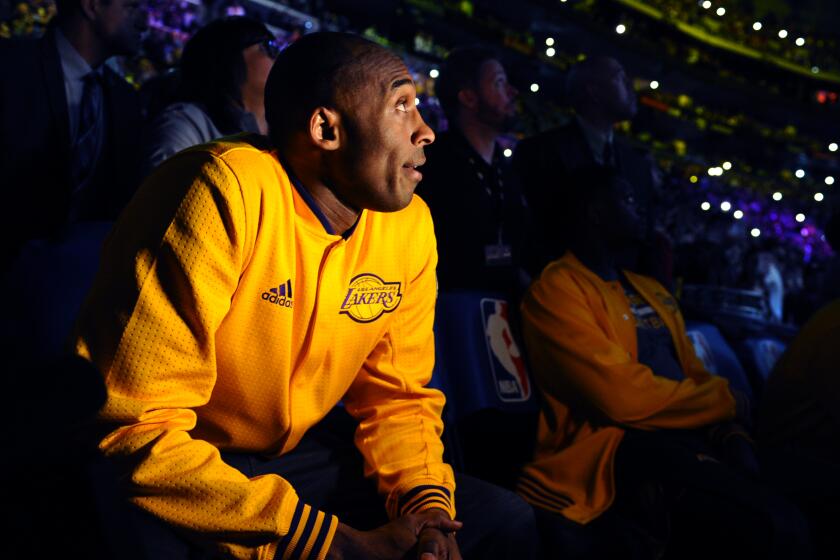 Lakers star Kobe Bryant watches a tribute video at Staples Center before the final game of his career on April 13, 2016.