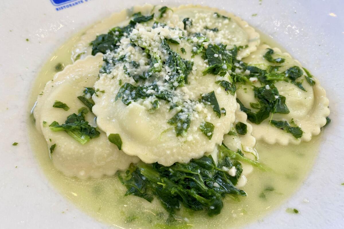 Spinach ravioli stuffed with spinach and ricotta and served with a Parmesan broth, garlic and sauteed spinach.