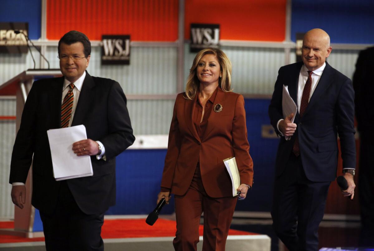 Moderators Neil Cavuto, left, Maria Bartiromo and Gerard Baker arrive on stage before the Republican presidential debate Tuesday in Milwaukee.