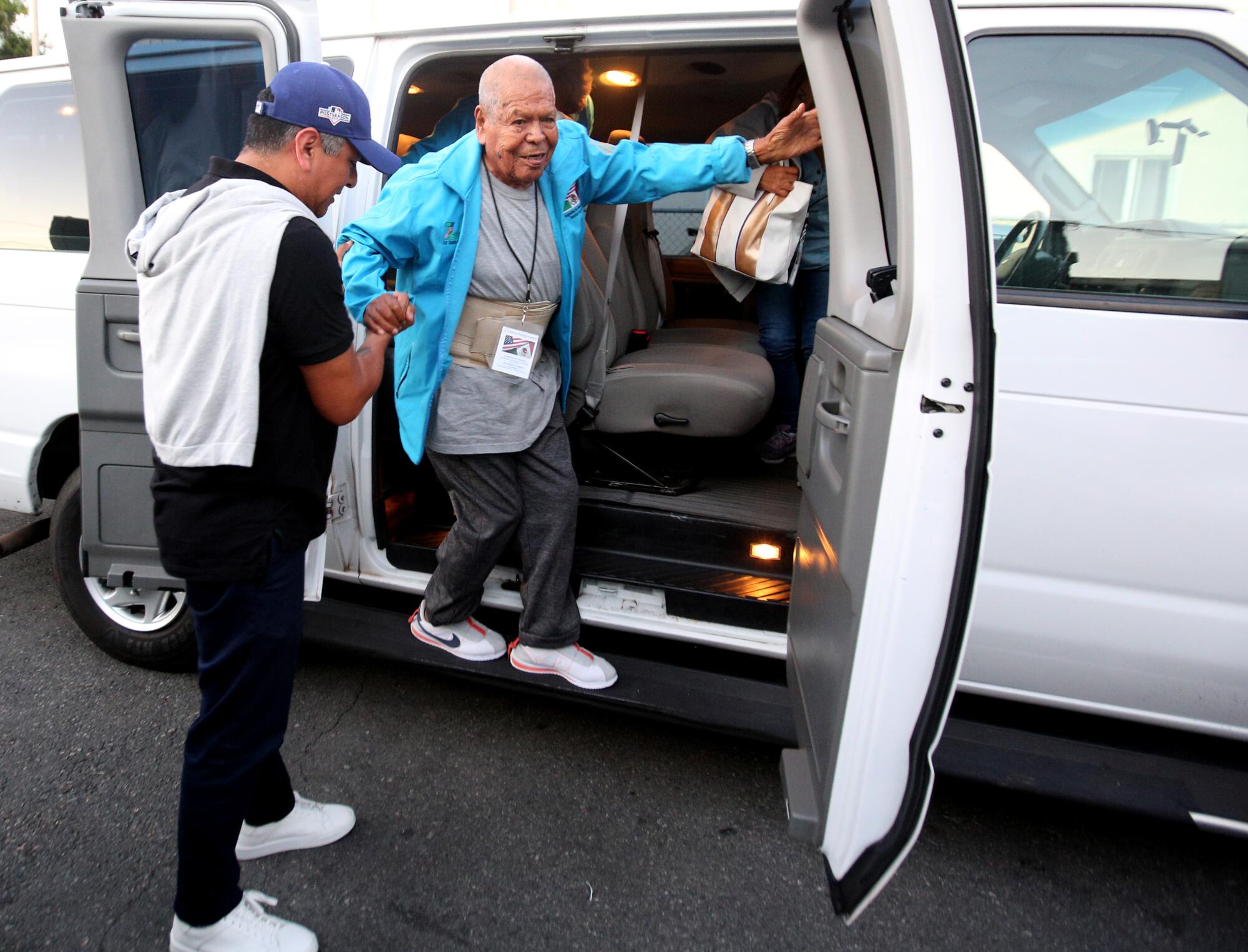 Ninety-year-old Ignacio Mendoza steps out of a white van