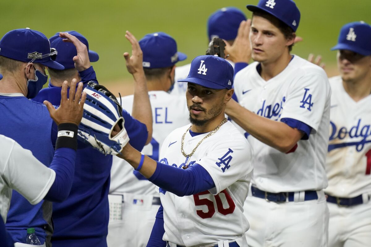 The Dodgers celebrate after their 3-1 win over the Atlanta Braves in Game 6 of the NLCS on Saturday.