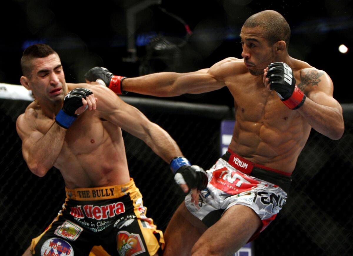 Jose Aldo, right, battles Ricardo Lamas during the second round of their featherweight title bout at UFC 169 in Newark, N.J. Aldo went on to win by unanimous decision.