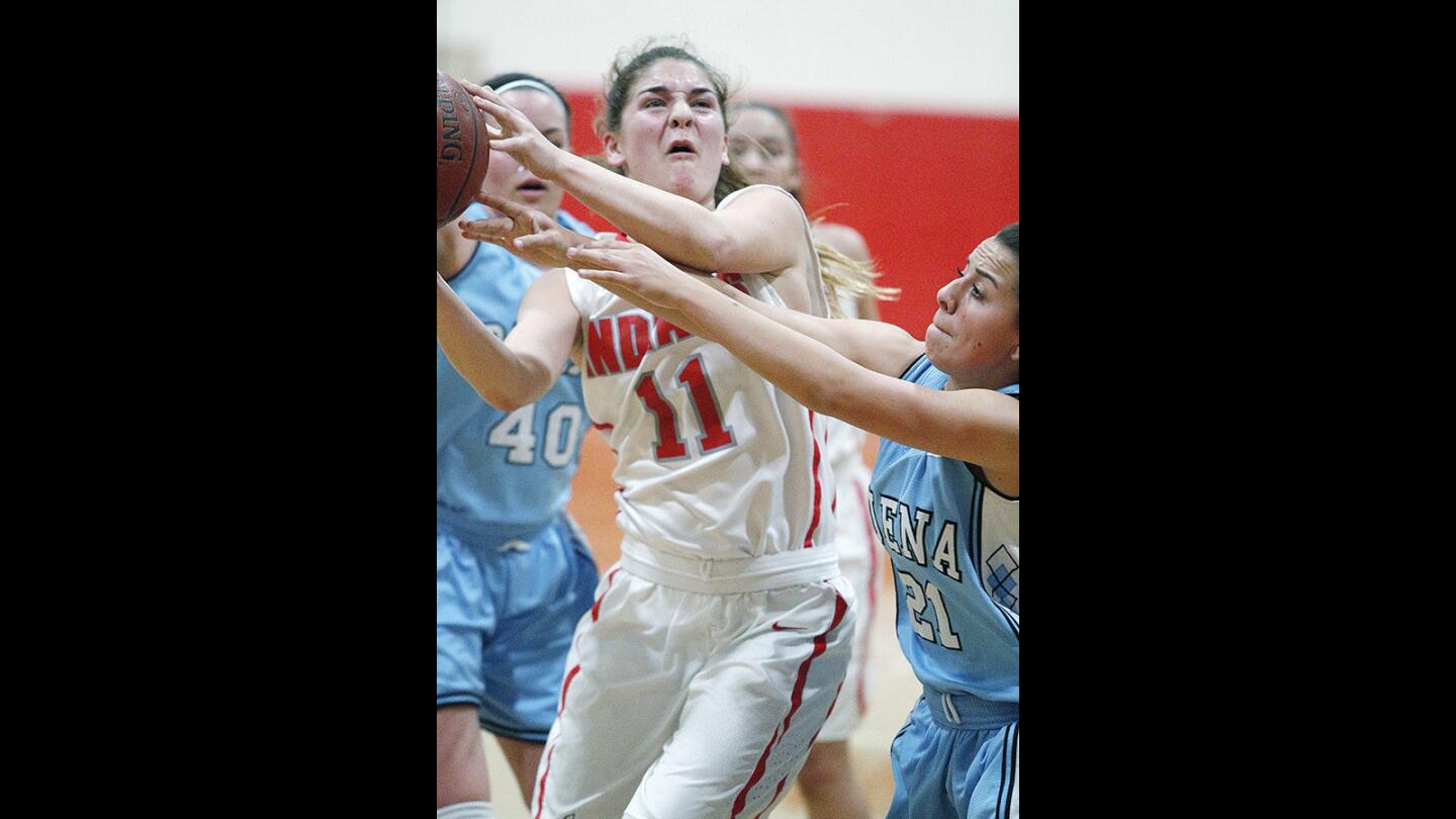 Burroughs' Kayla Wrobel fights to the basket against Buena's Jelly Orozco in a first round CIF Division II-A playoff girls' basketball game at Burroughs High School on Thursday, February 15, 2018. Burroughs won the game 41-38.