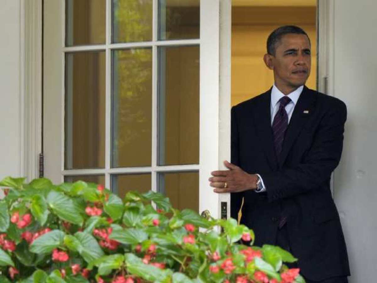 President Obama walks from the Oval Office of the White House on Tuesday.