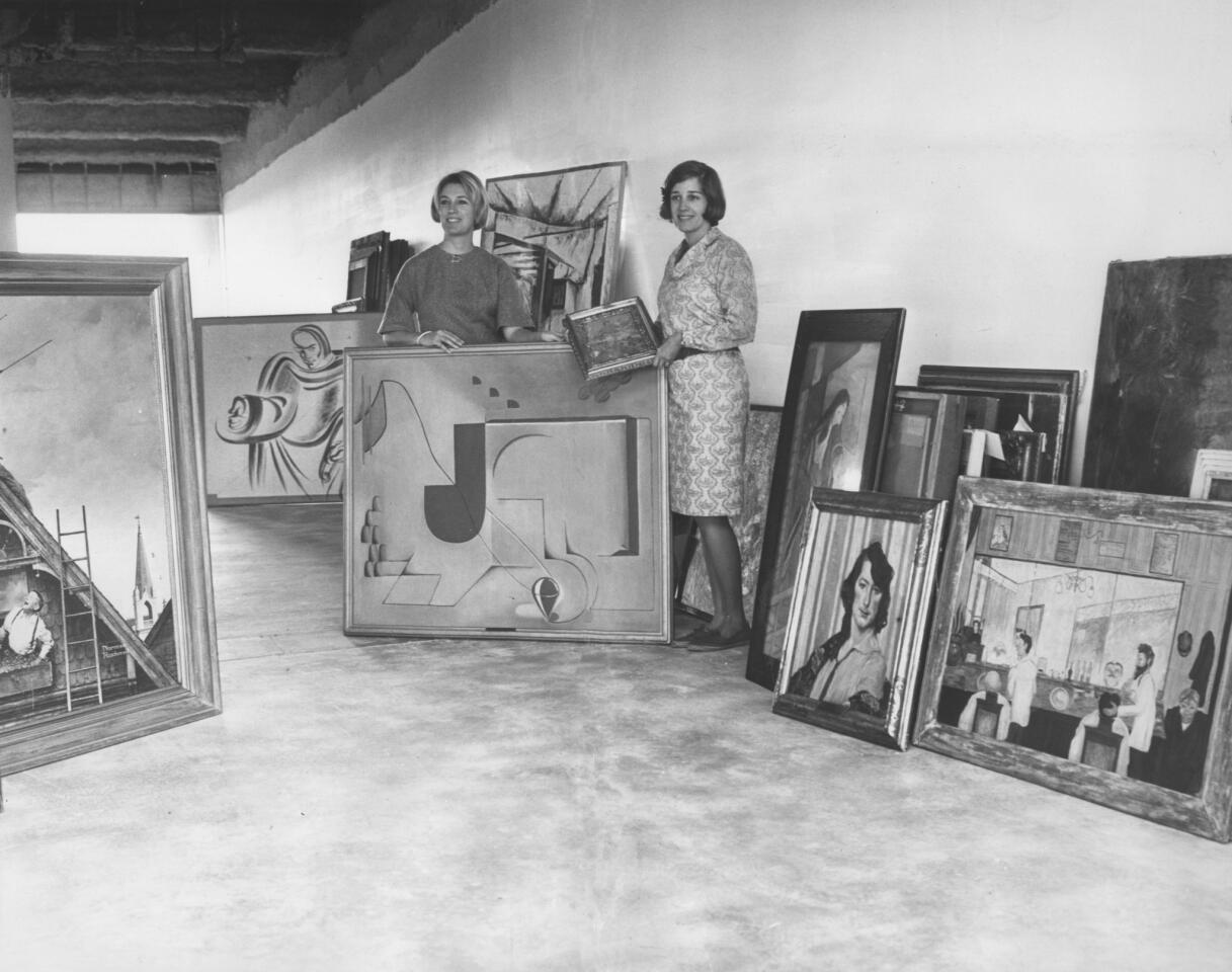 On Nov. 22, 1966, two women affiliated with the museum arrange a few of the paintings to be featured in a sale held by the Art Museum Council.
