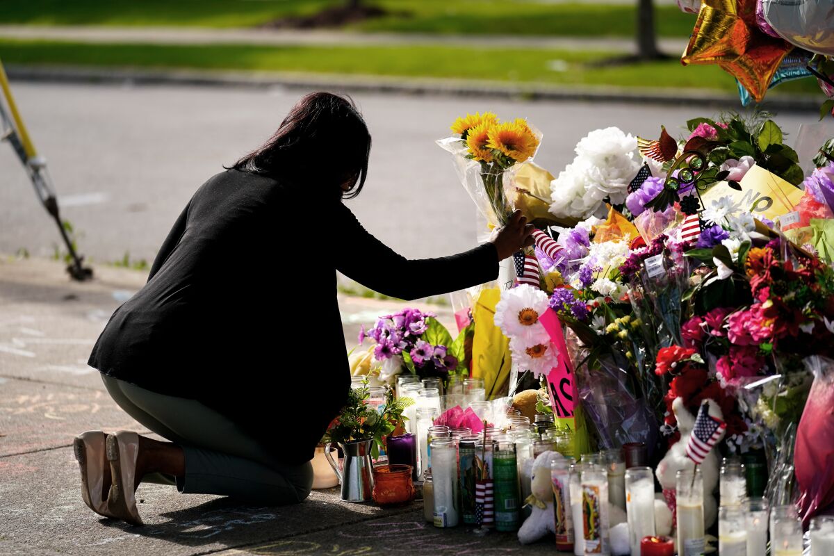 Shannon Waedell-Collins pays her respects at the scene of Saturday's shooting at a supermarket, in Buffalo, N.Y.