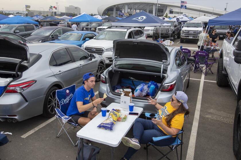 INGLEWOOD, CA - AUGUST 14, 2021- Rane Laymance, left, and Kristin Malley, right enjoy tailgating in the parking lot outside SoFi Stadium Saturday, Aug. 14, 2021 in Inglewood, CA. (Brian van der Brug / Los Angeles Times)