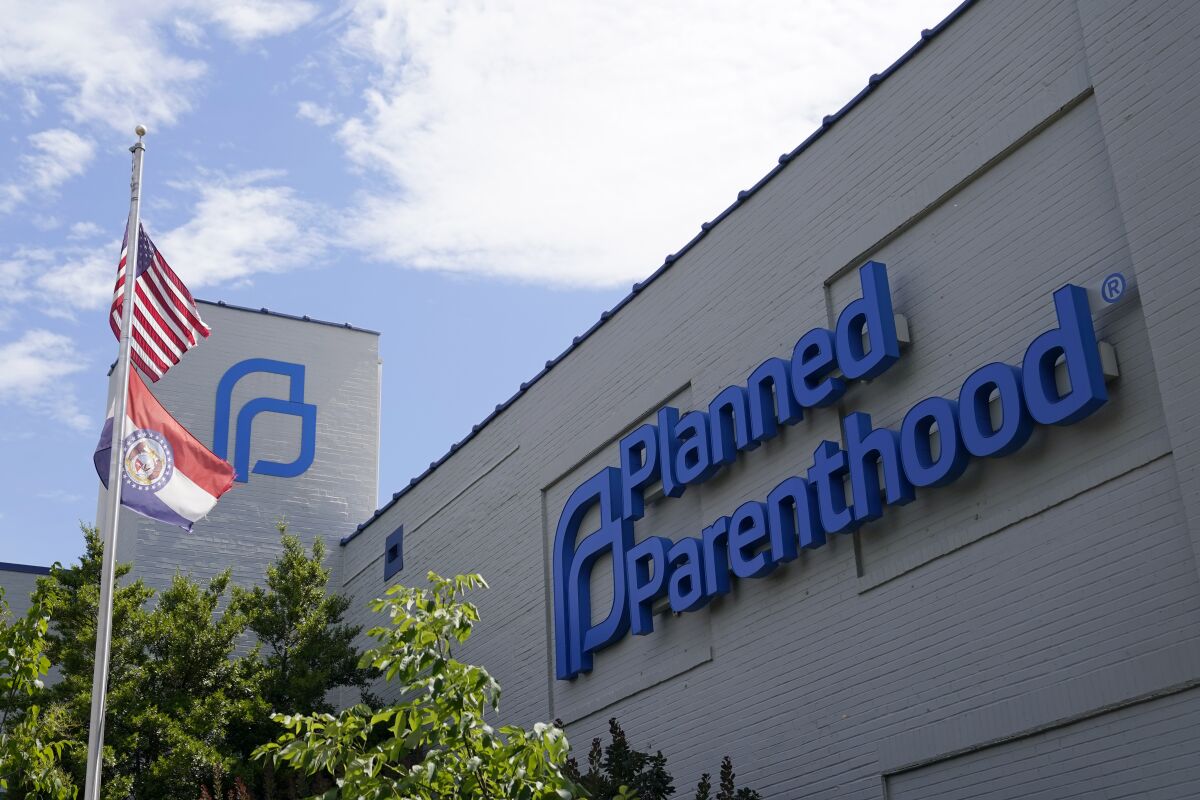 FILE - Missouri and American flags fly outside Planned Parenthood June 24, 2022, in St. Louis. Planned Parenthood