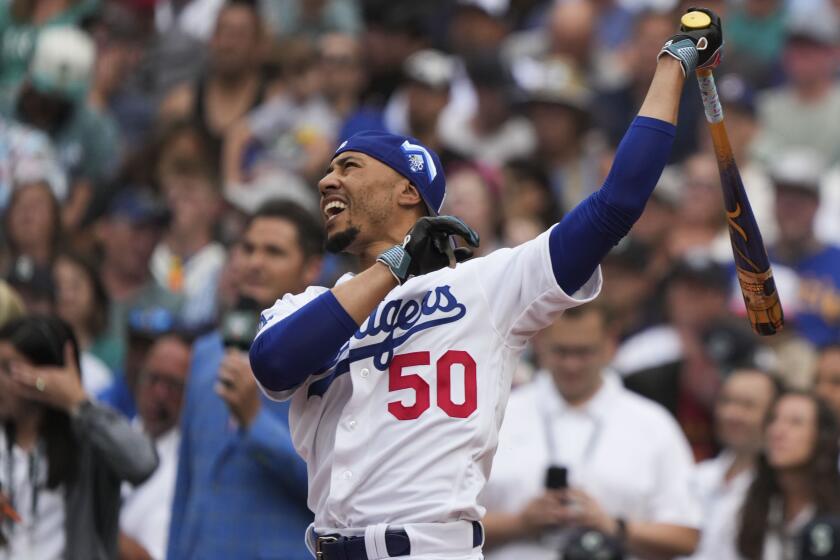 National League's Mookie Betts, of the Los Angeles Dodgers, hits during the first round.