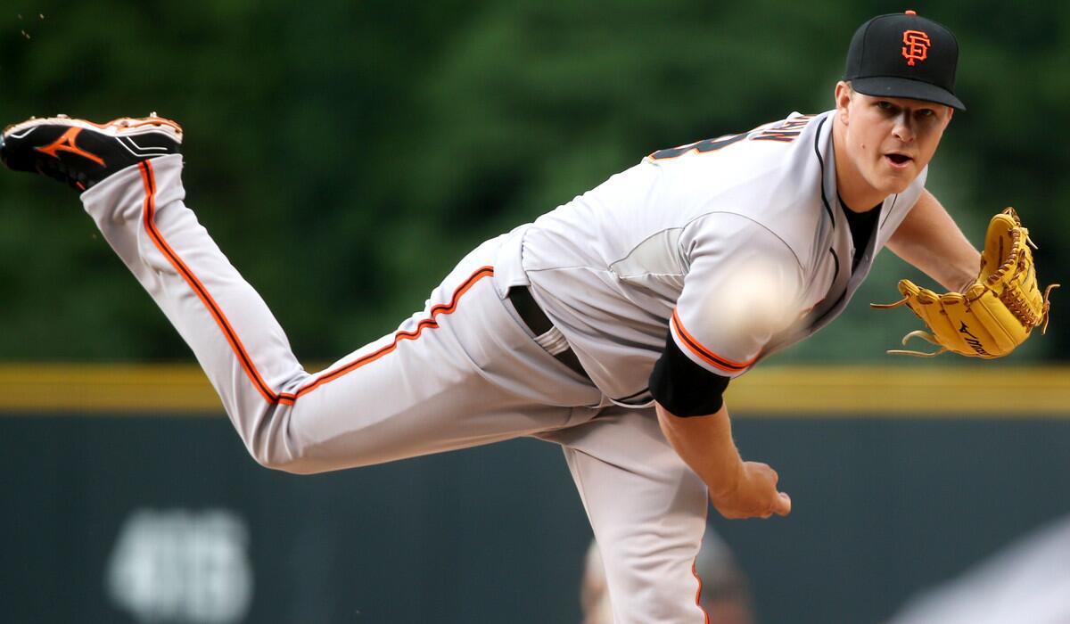 Giants starting pitcher Matt Cain works against the Colorado Rockies in the first inning of a game on Wednesday in Denver.