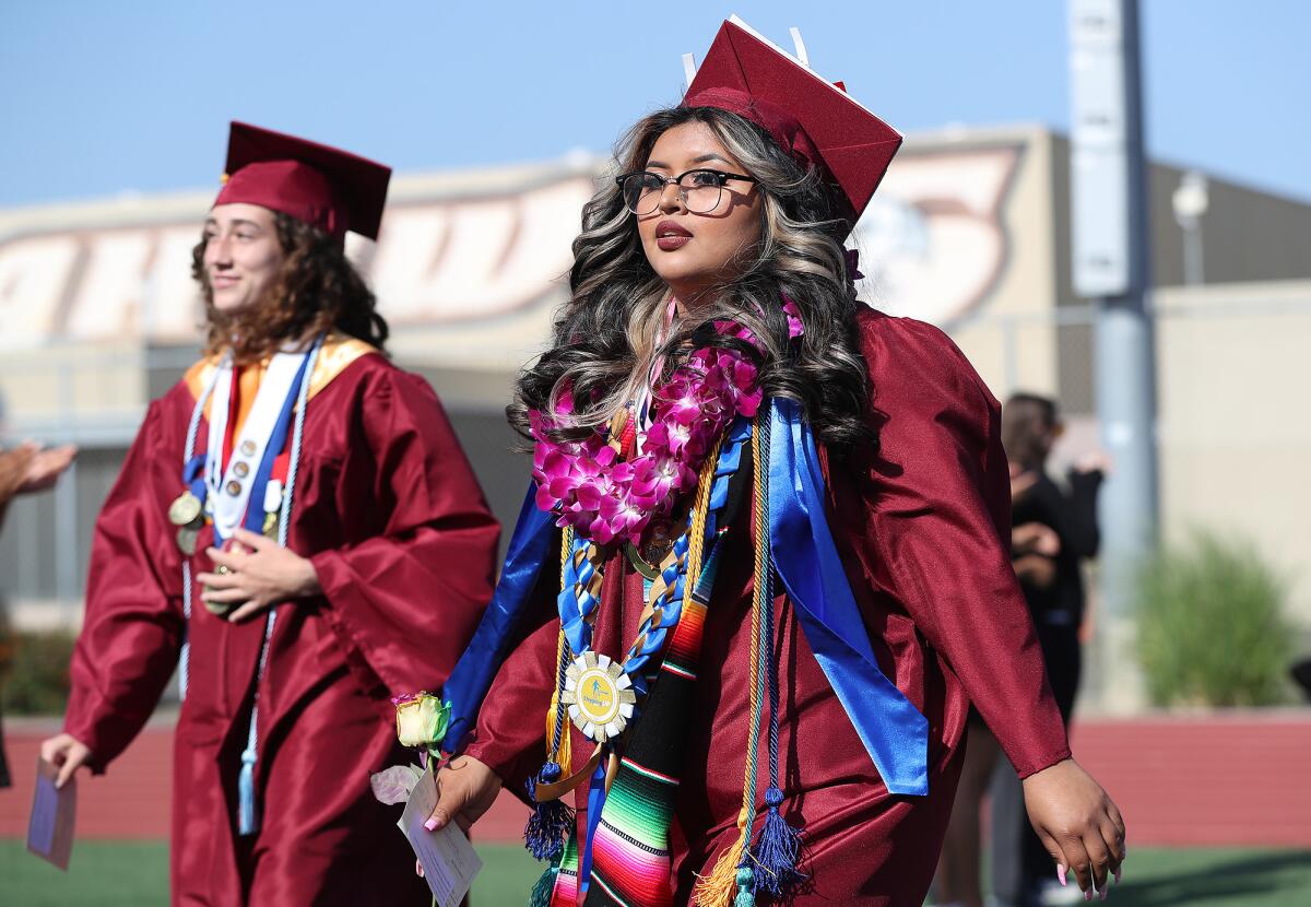 Decorated graduate Jocelyn Aragon walks the processional to the Ocean View High graduation ceremony on Wednesday.