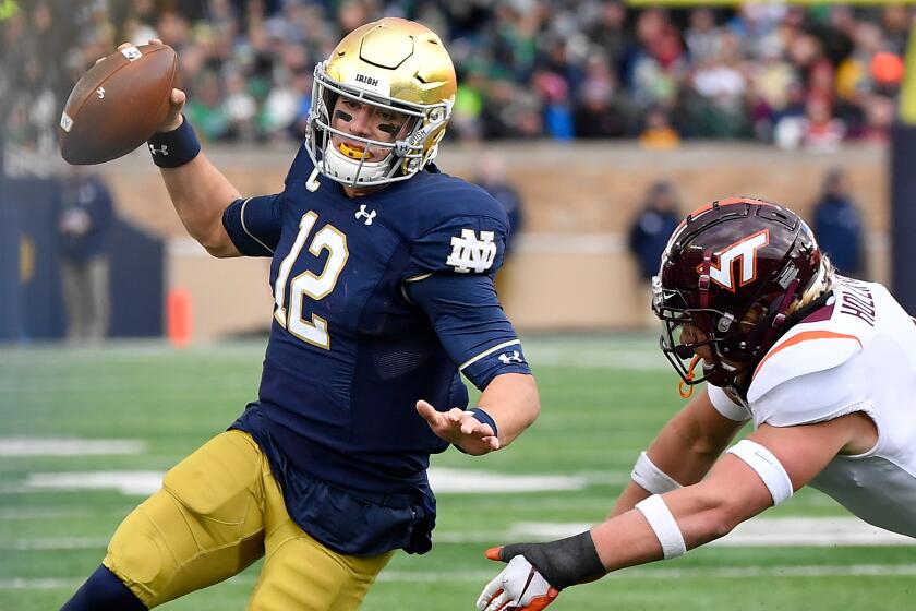 SOUTH BEND, INDIANA - NOVEMBER 02: Ian Book #12 of the Notre Dame Fighting Irish scrambles in the first half against the Virginia Tech Hokies at Notre Dame Stadium on November 02, 2019 in South Bend, Indiana. (Photo by Quinn Harris/Getty Images) ** OUTS - ELSENT, FPG, CM - OUTS * NM, PH, VA if sourced by CT, LA or MoD **